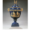 The Mediterranean Maiolica by Schiffer Publishing, Ltd. is a blue and gold lusterware vase with a lid, featuring sculpted classical figures, intricate patterns, two gold figurines on top, and a pedestal base prized by collectors.
