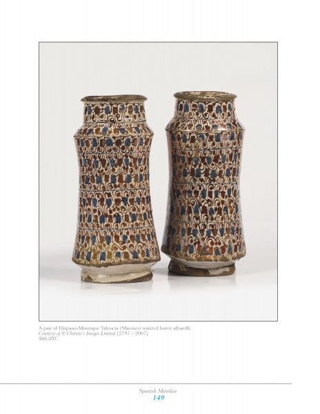 Mediterranean Maiolica by Schiffer Publishing, Ltd. features two tall, narrow cylindrical vases with flared rims, showcasing intricate brown, blue, and white geometric and floral glazed designs, set against a white background. Collectors highly value these pieces.