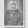 Black-and-white portrait of a stern man in decorated WWII Waffen-SS panzer uniform, with medals and insignia. Below is a caption and page 115 from "Panzer Divisions of the Waffen-SS" by Schiffer Publishing, Ltd.