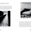 Two black-and-white photos from "Open Aperture" (Schiffer Publishing, Ltd.): a shadowed brick street beneath clouds, and a reclining nude by the sea—both examples of fine art photography by avant-garde photographer Bill Brandt.
