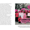 A group of women in pink—emphasizing the cultural meaning of color—hold signs at an outdoor rally, including one reading CODE PINK: WOMEN FOR PEACE. Some wear pink hats, echoing ideas from Deep Color by Schiffer Publishing, Ltd.