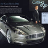Indoors, 007 James Bond stands in a tuxedo beside a silver Aston Martin DBS. The Casino Royale logo glows behind them, capturing Ian Fleming’s world. On the right, discover Schiffer Publishing’s "101 Things You Should Know about James Bond 007.