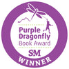 A circular purple badge with a dragonfly and a child holding its tail above "Purple Dragonfly Book Award SM WINNER," perfect for celebrating Schiffer Publishing's beginner picture book "I Think I Can.
